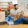 Happy couple celebrating after unpacking boxes with the help of professional movers and packers and a trusted removalist Rockingham.