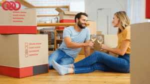 Happy couple celebrating after unpacking boxes with the help of professional movers and packers and a trusted removalist Rockingham.