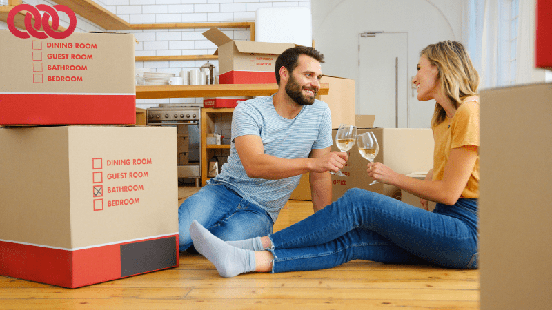 Happy couple celebrating after unpacking boxes with the help of professional movers and packers and a trusted removalist Rockingham.